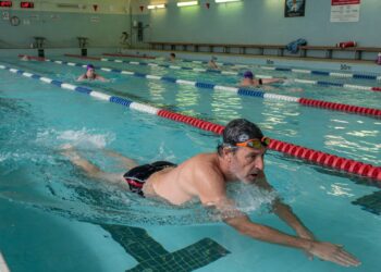 mans winning lengths of the pool to improve his fitness