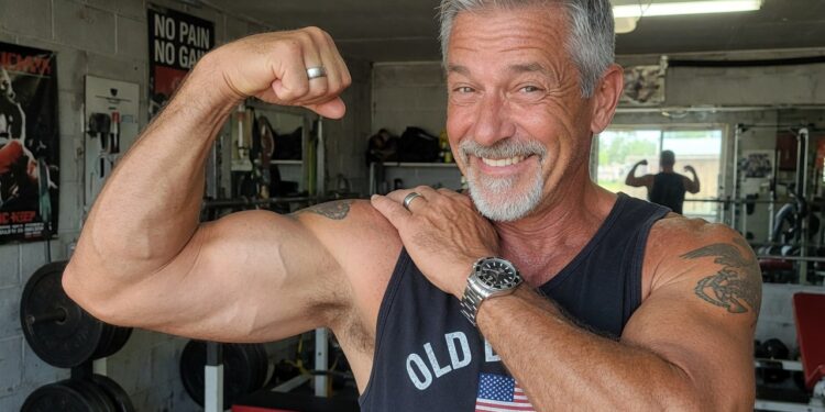 55 year old man showing off his big biceps